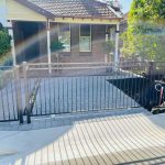 Paved driveway with custom fence