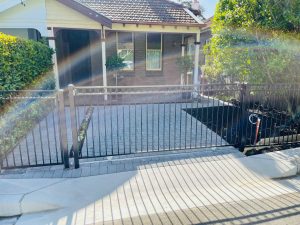 Paved driveway with custom fence