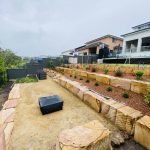 Terraced landscaping with sandstone retaining wall