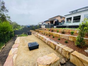 Terraced landscaping with sandstone retaining wall