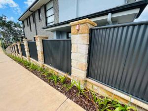 Sandstone fence pillar corrugated iron inserts