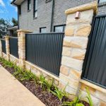 Sandstone and corrugated iron fence