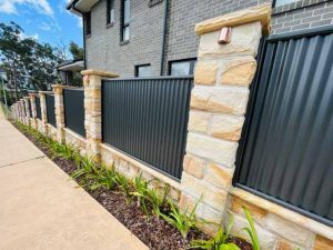 Sandstone and corrugated iron fence