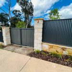 Corrugated iron gates and sandstone pillars