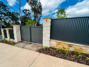 Corrugated iron gates and sandstone pillars