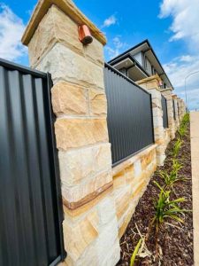 Sandstone Pillar Fence with corrugated iron panels