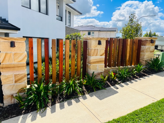 Timber slatted Fence with sandstone pillars