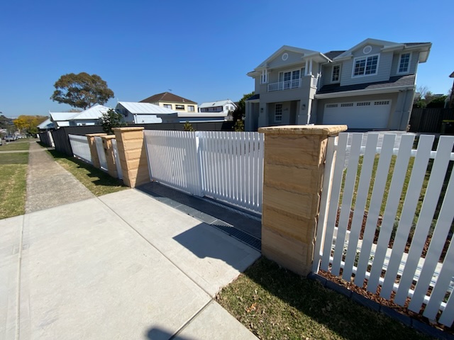 timber fence with sandstone pillars