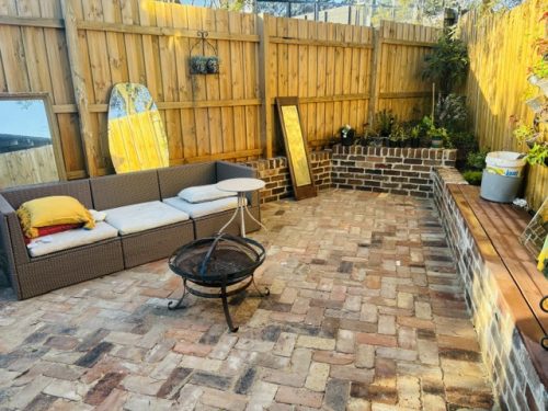 Reclaimed brick paved firepit and outdoor couch